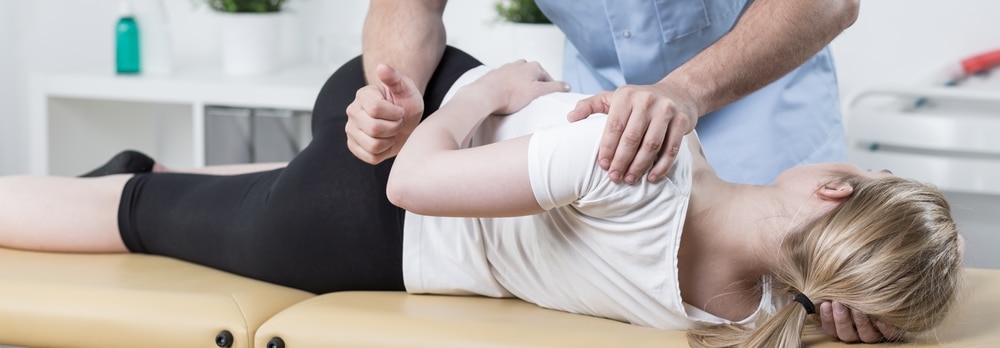 Chiropractor for hip pain treatment does a lower lumbar adjustment