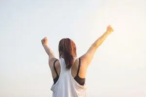 woman chering with her hands in the air