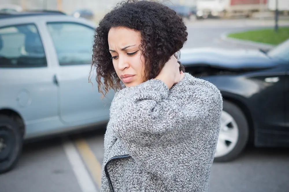 Woman with Whiplash experiences neck pain and seeks treatment at Kosak chiropractic