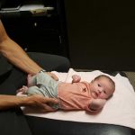 photo of a baby on a chiropractic table