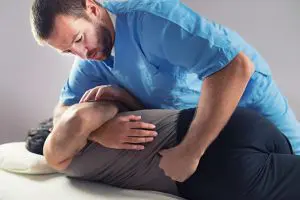 chiropractor adjusting patients lower back