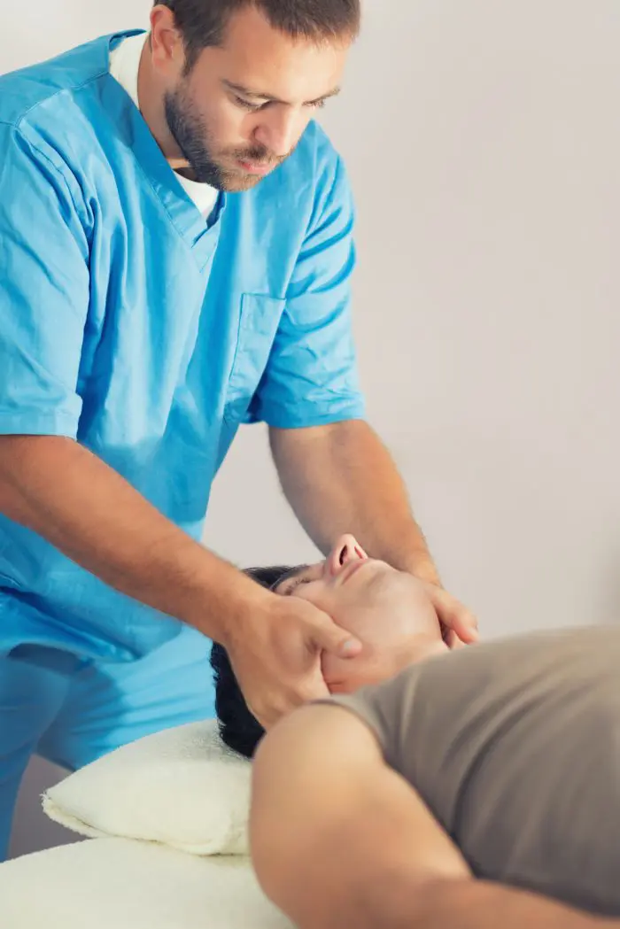 chiropractor adjusting a patients neck