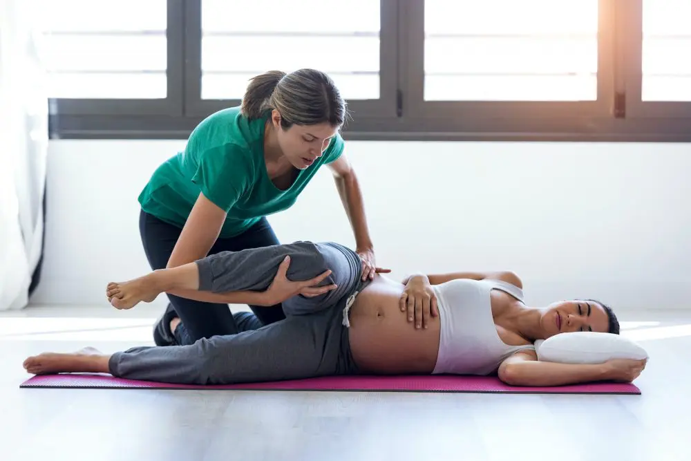 chiropractor adjusting pregnant moms back 