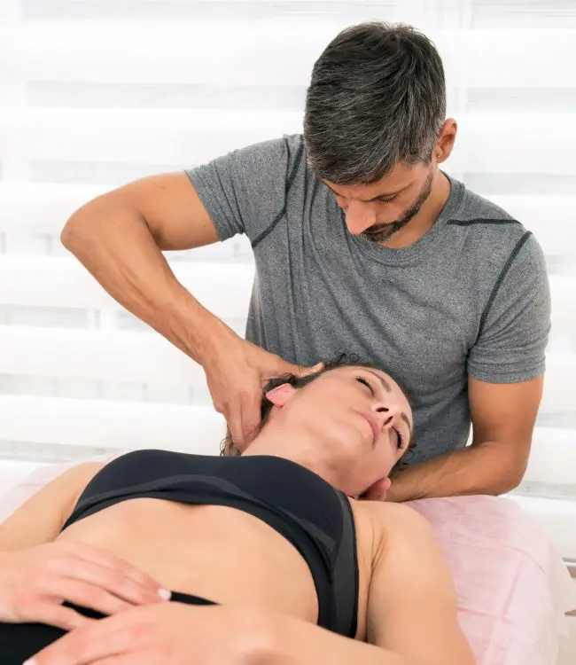 chiropractor adjusting patients neck