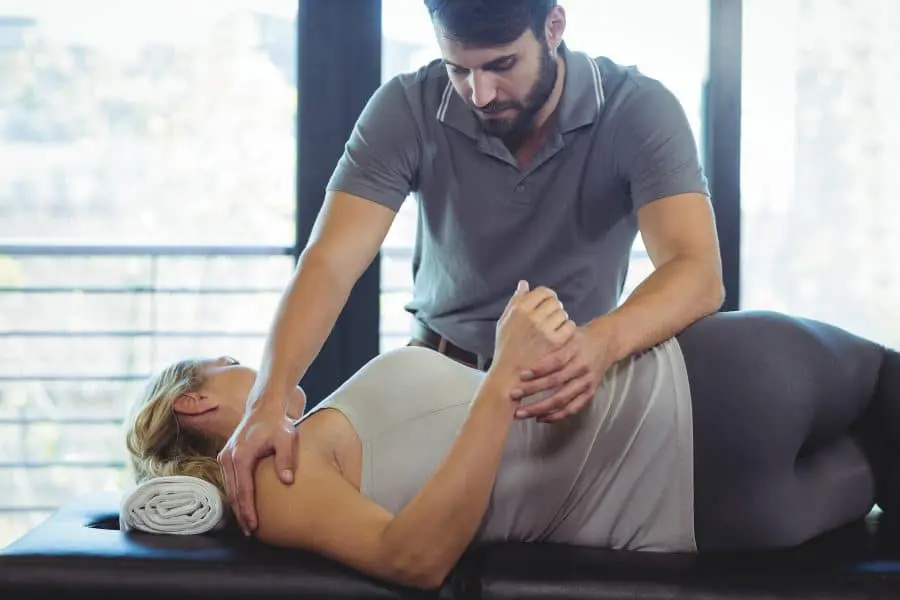 chiropractor adjusting patients back