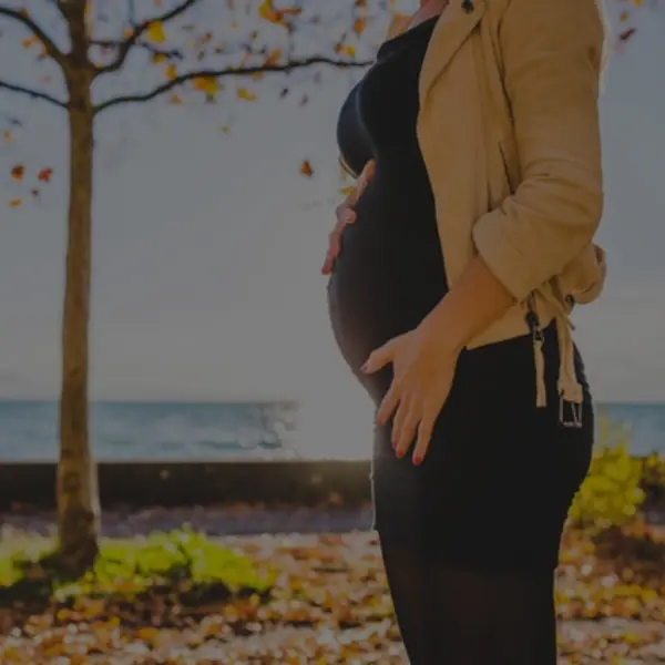 pregnant woman's belly with the ocean on the background