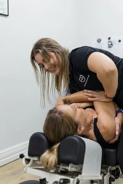 Chiropractor doing chiropractic adjustment to a female patient