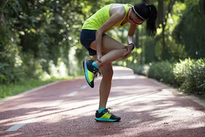 Athlete woman suffered from sports injury after getting into an accident while doing some stretching in the park 