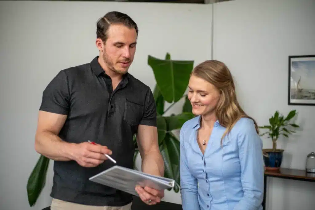 Chiropractor explaining the health insurance information to the patient before the treatment.