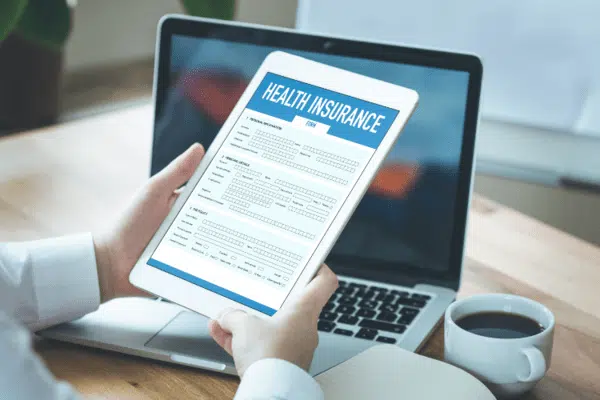 Health insurance form on the tablet screen.