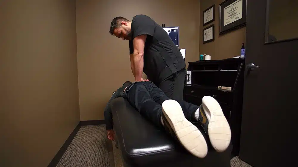 Chiropractor doing some chiropractic adjustment to the patient.