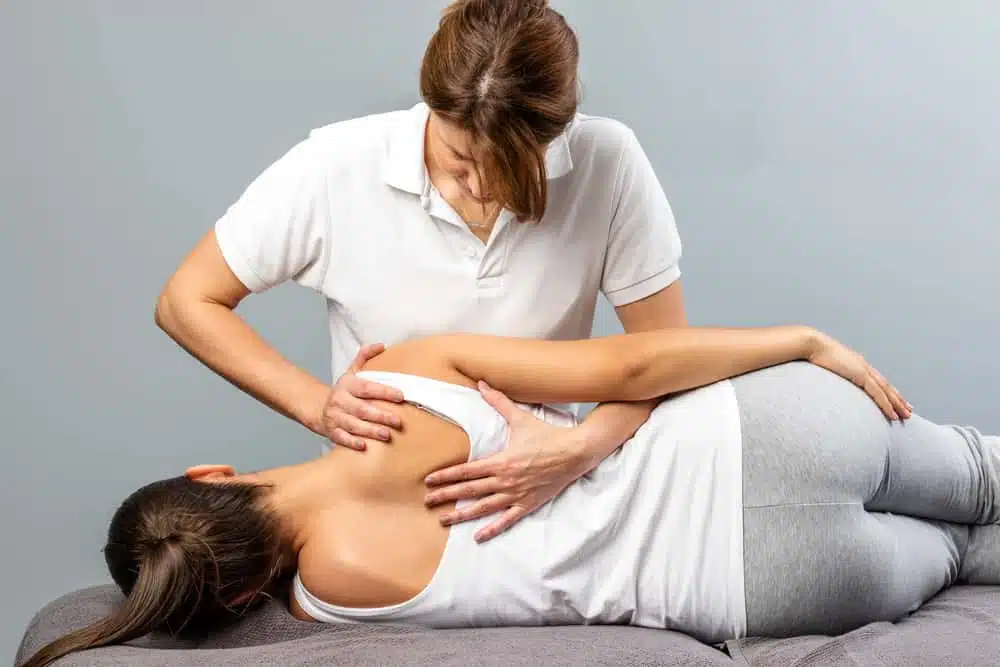 Female chiropractic doing some chiropractic adjustment to the patient.