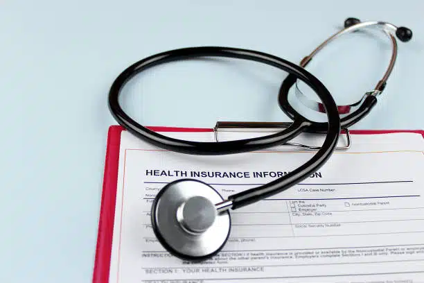 health insurance form with stethoscope.