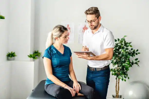 Chiropractor explaining the health insurance benefits to the patient.