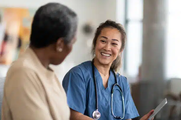 A chiropractor and a patient having a conversation at the chiropractic clinic.