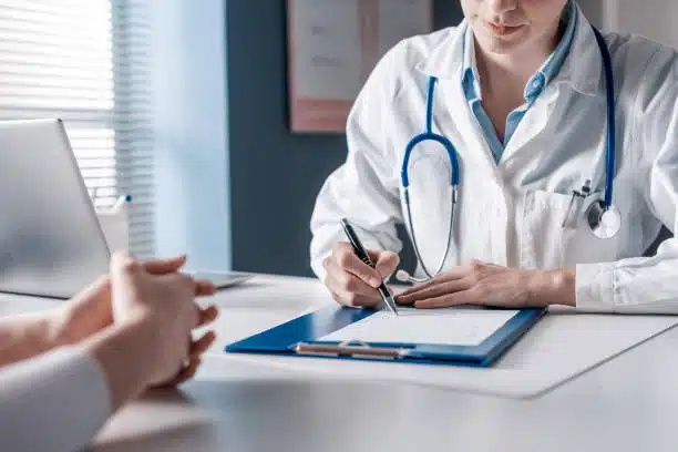 Patient with health insurance having an evaluation with a chiropractor.