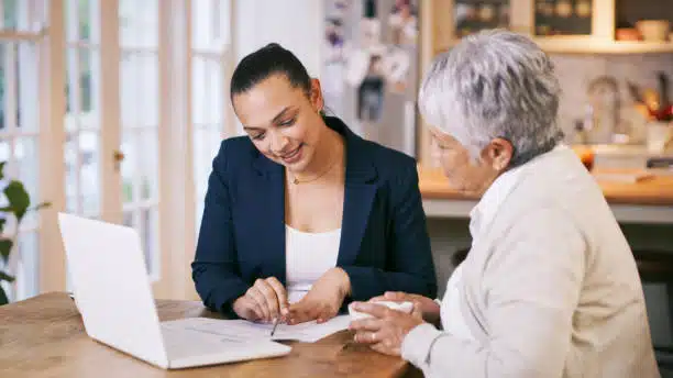 Senior woman checking her health insurance policy and information with the advisor.