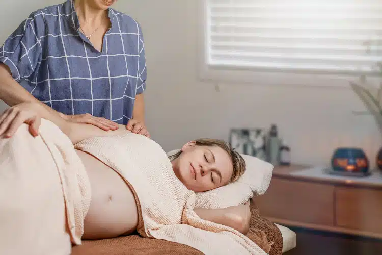 Pregnant woman undergoing prenatal chiropractic care treatment.