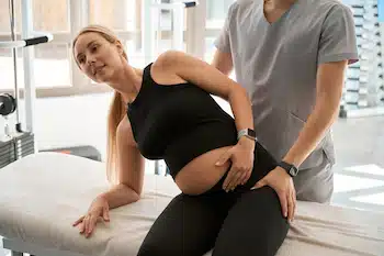 Pelvic Alignment session for pregnant woman in chiropractic clinic