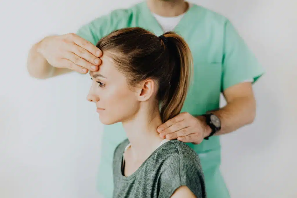 Professional Massage Therapist Treating a Female Patient's Injured Neck